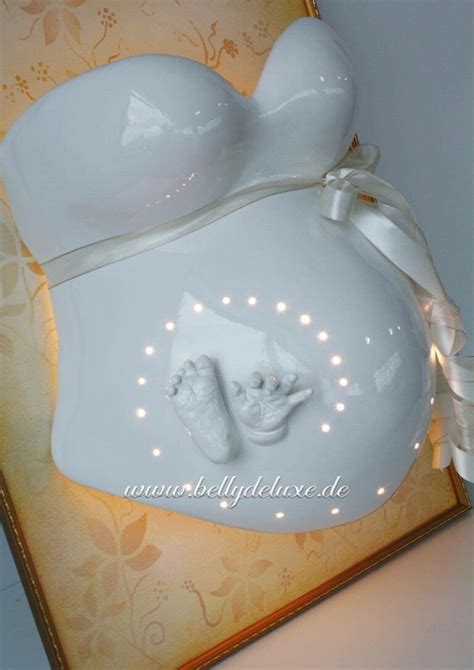 Ein bemalter und verzierter Gipsabdruck vom Babybauch mit Namen und Geburtsdatum des Kindes