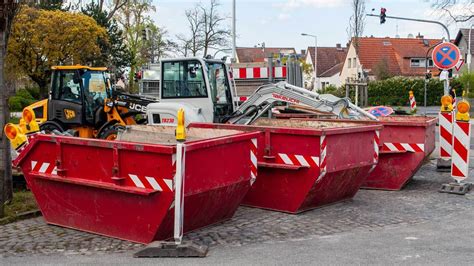 Panoramablick auf die Jalbert Brothers Abfallentsorgung mit verstreuten Fässern und provisorischen Befestigungen