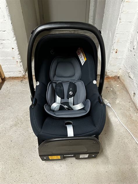 Schema der Maxi-Cosi Tinca Babyschale mit hervorgehobenen Sicherheitselementen