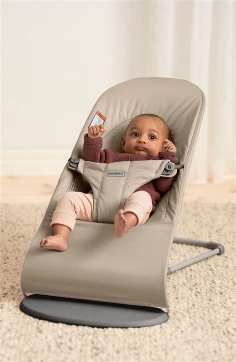 Baby in der BabyBjörn Balance Soft mit einem optionalen Spielbogen